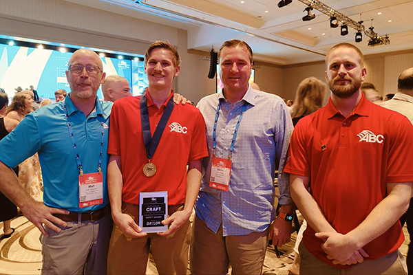 ABC Construction Awards Ceremony Four men posing for photo at awards banquet