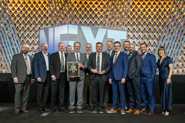 Line of professionals at formal awards banquet accepting award on stage