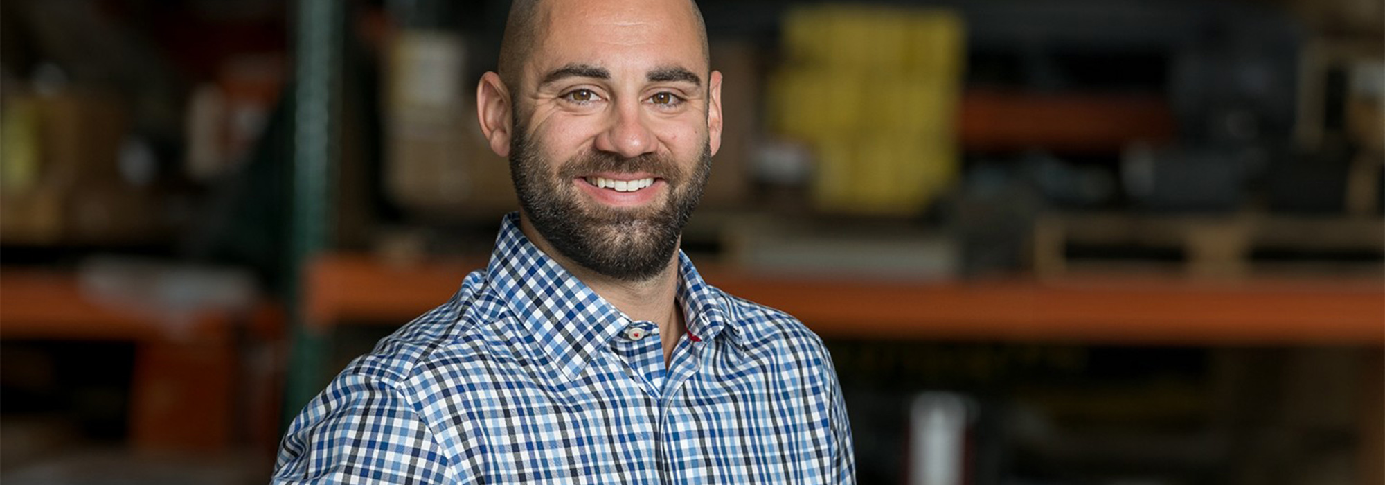 Man smiling at camera in warehouse