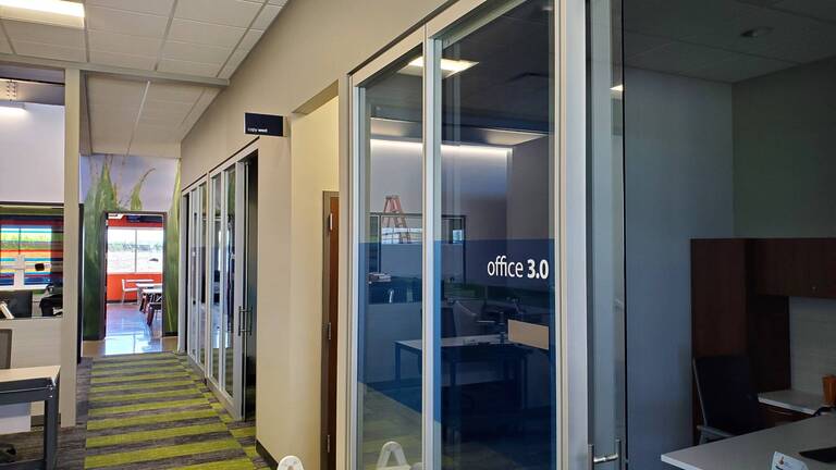 Modern office hallway with glass doors