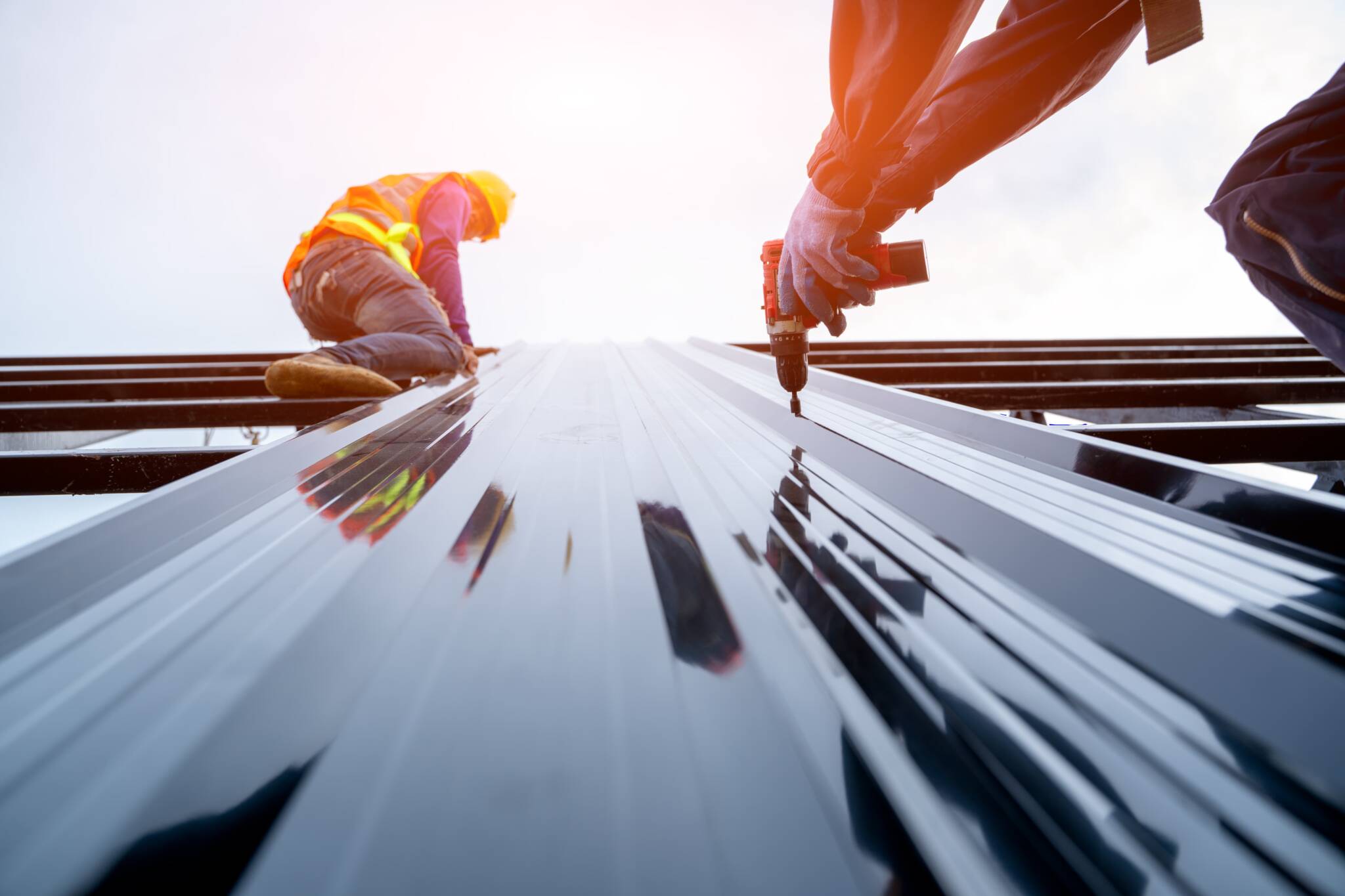 Two men working on a building